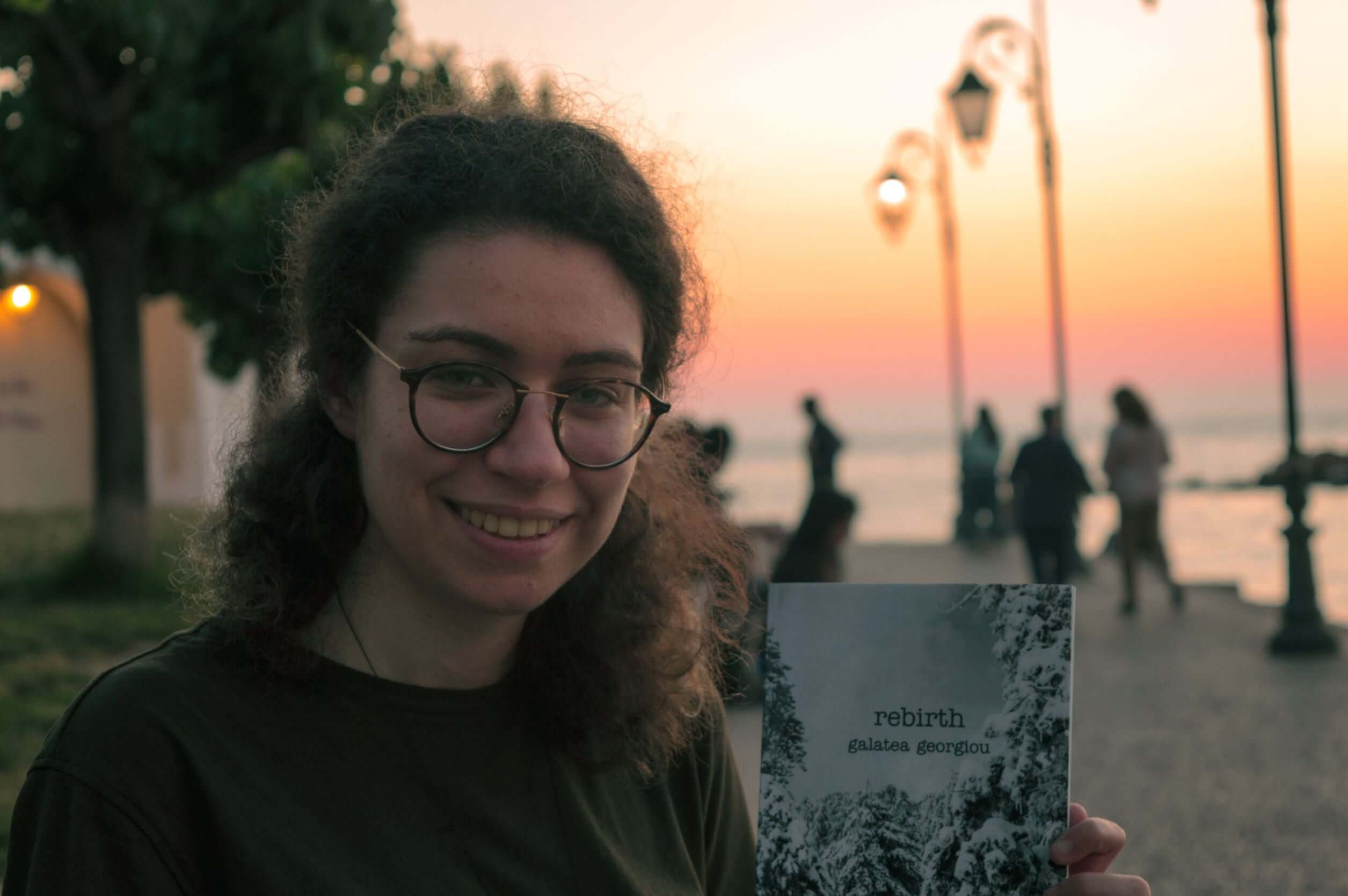 Galatea Georgiou holding her book rebirth 