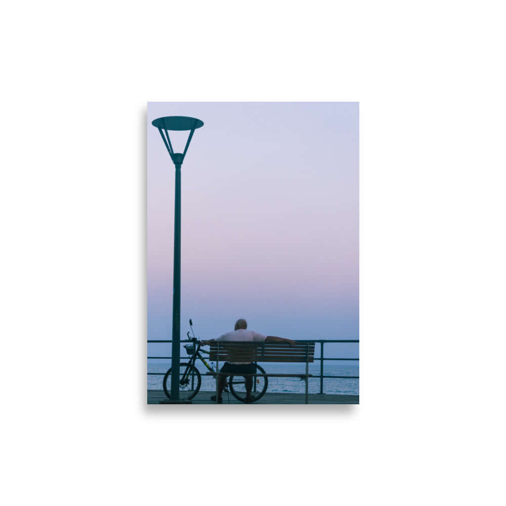 Man sitting on a bench during sunset