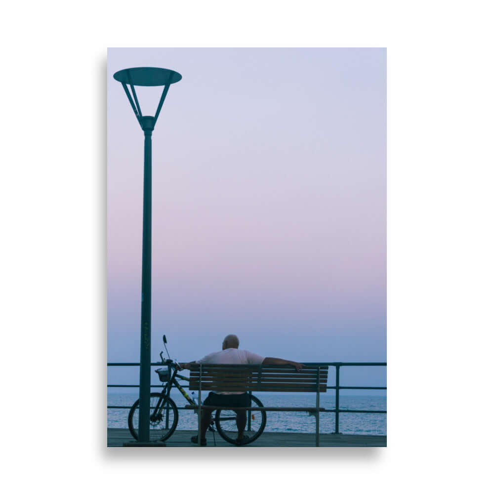 Man sitting on a bench during sunset