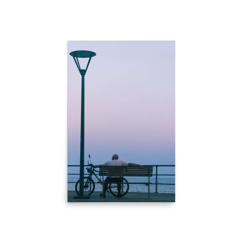 Man sitting on a bench during sunset