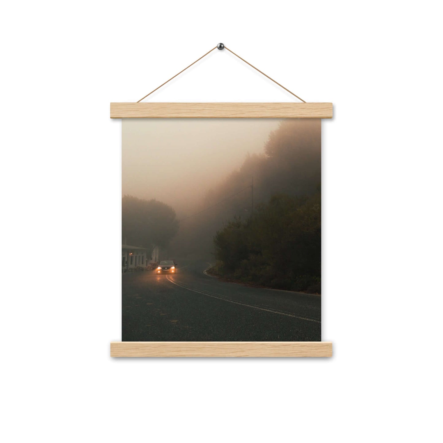 Poster with hangers of a car driving in a foggy scenery