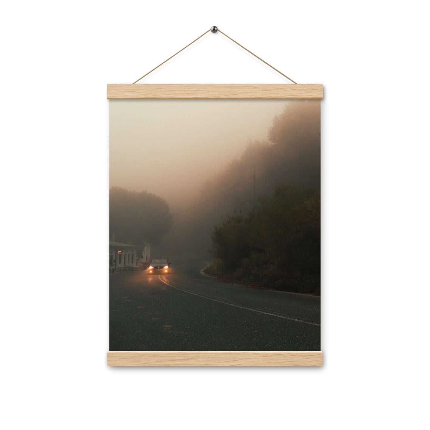 Poster with hangers of a car driving in a foggy scenery