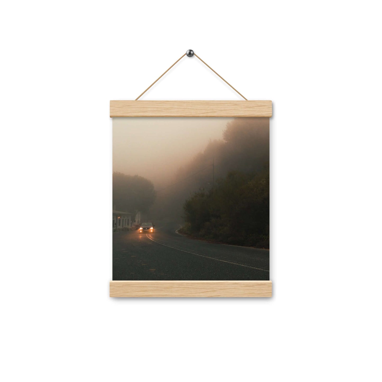 Poster with hangers of a car driving in a foggy scenery