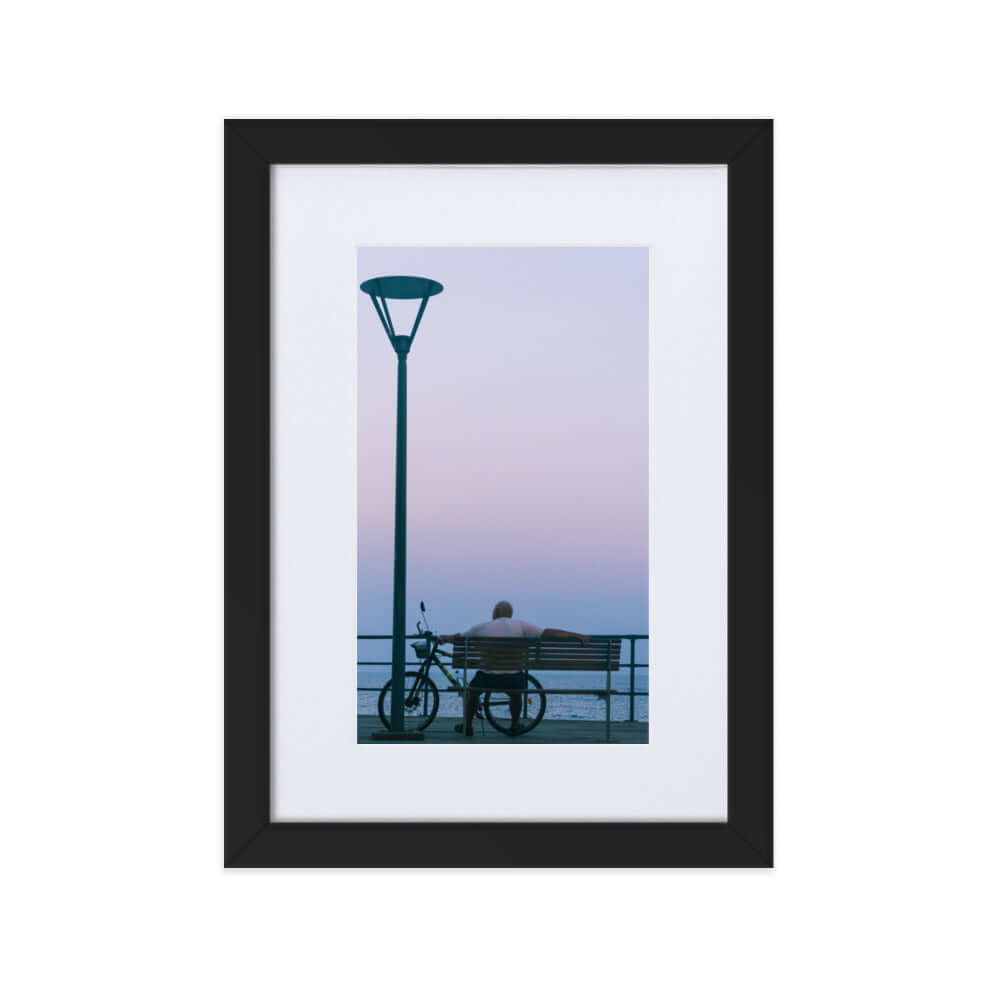 Man sitting on a bench during sunset