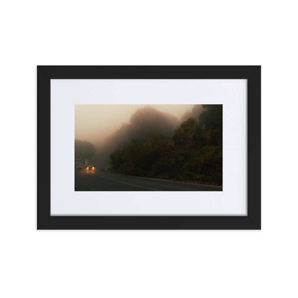 Black Framed Photograph of a car driving in a foggy scenery