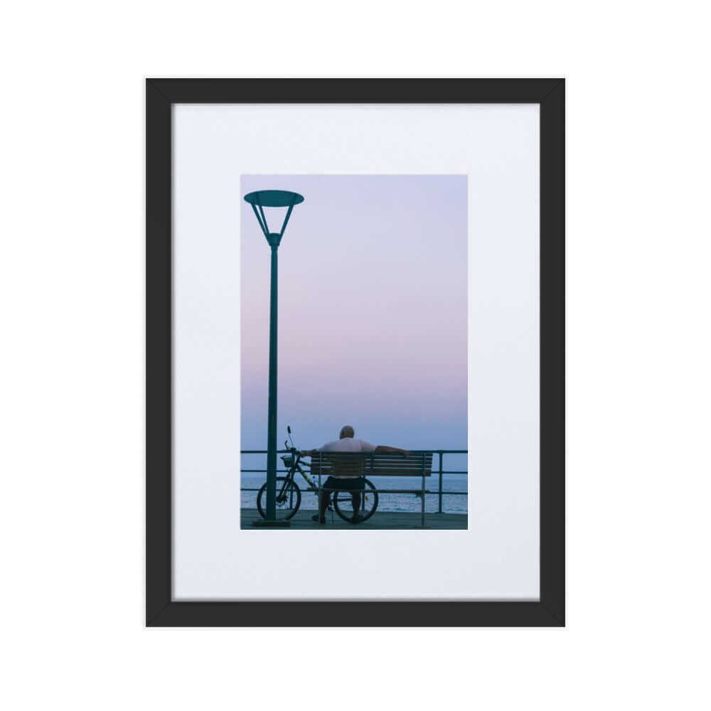 Man sitting on a bench during sunset