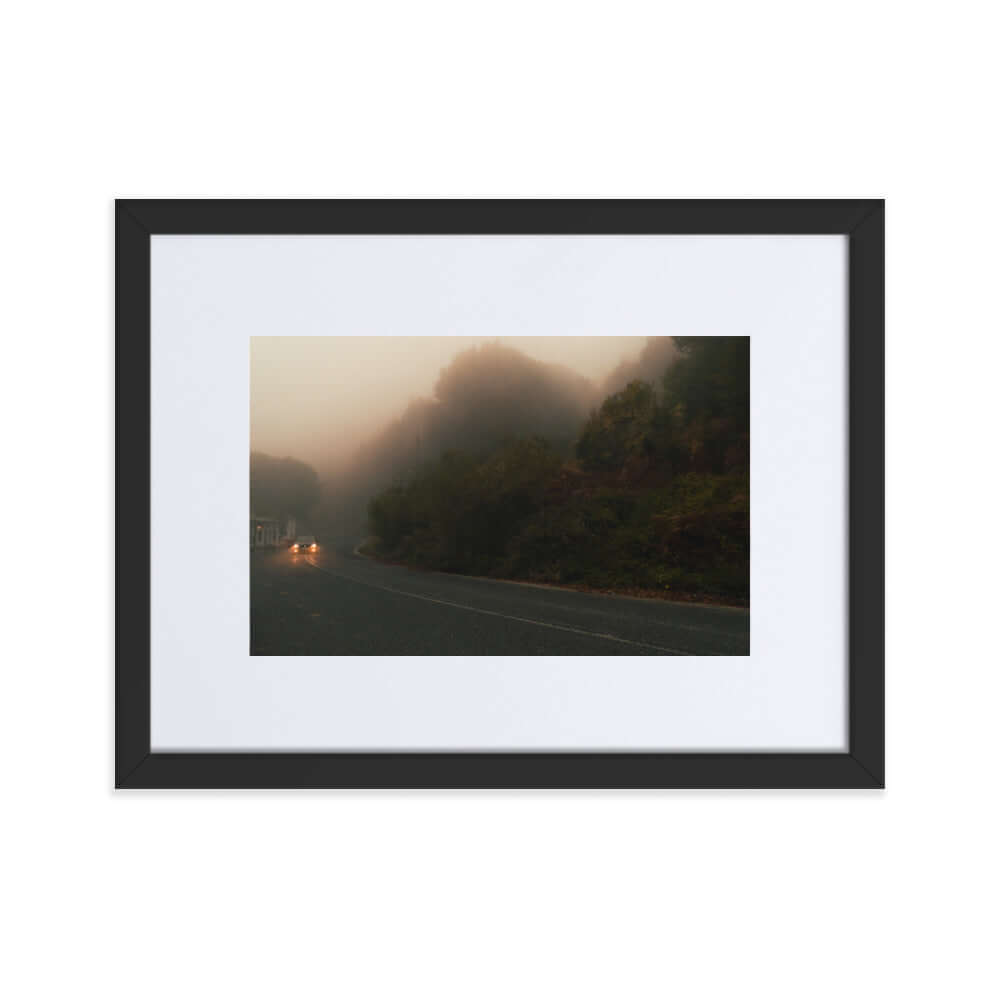 Black Framed Photograph of a car driving in a foggy scenery