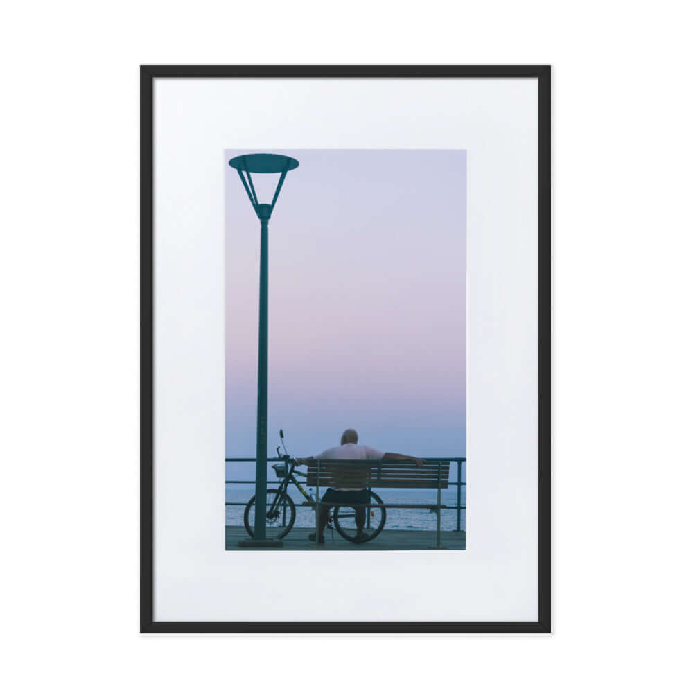 Man sitting on a bench during sunset