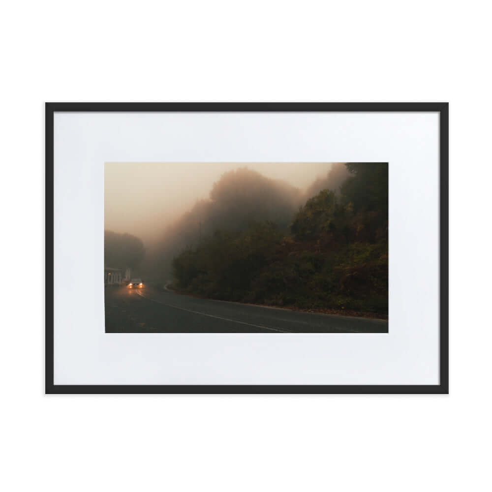 Black Framed Photograph of a car driving in a foggy scenery