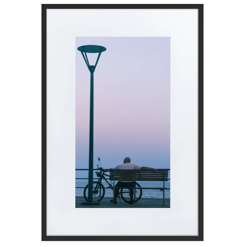 Man sitting on a bench during sunset