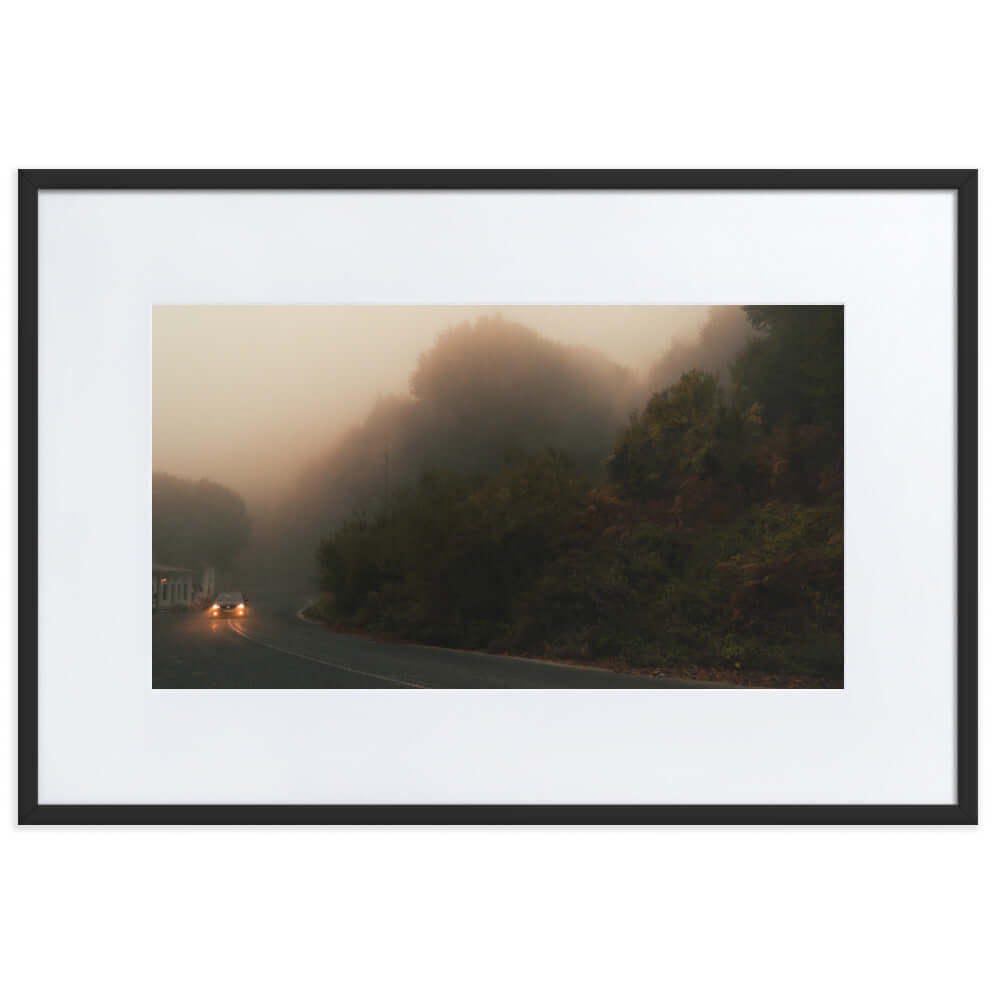 Black Framed Photograph of a car driving in a foggy scenery