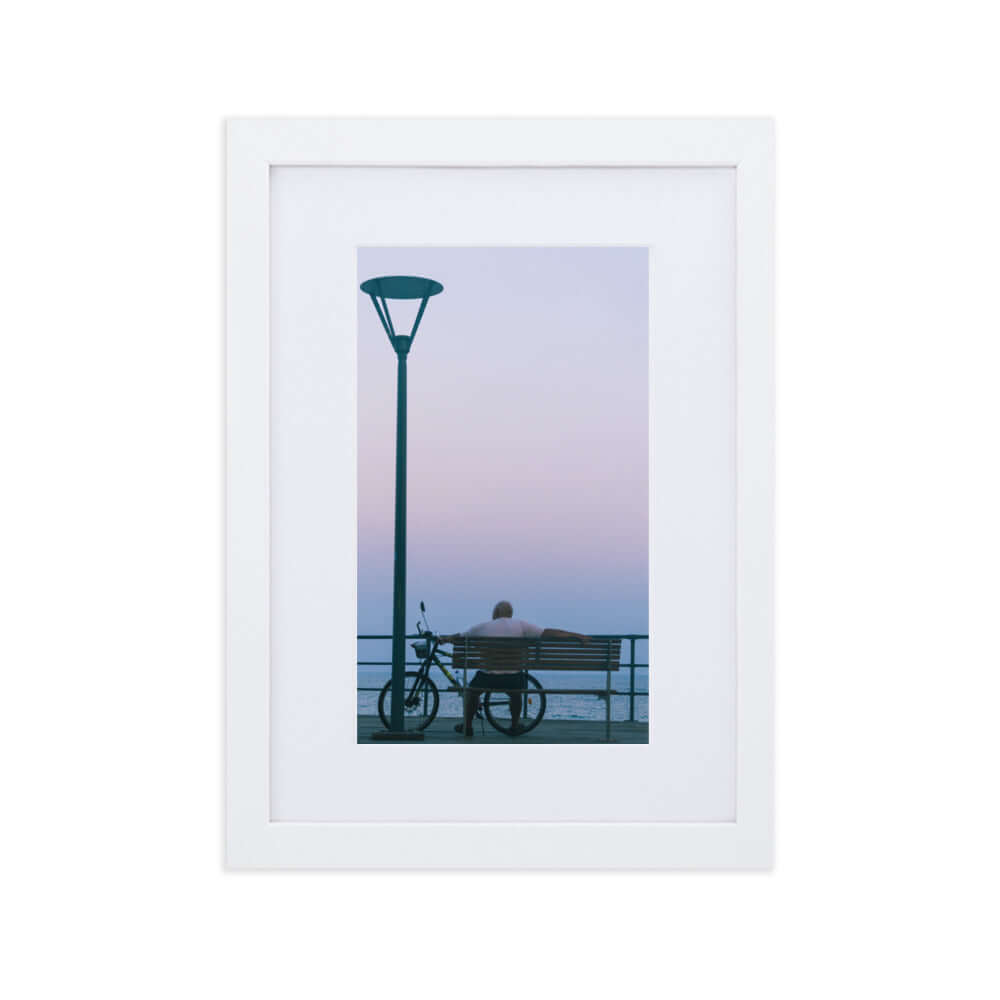 Man sitting on a bench during sunset