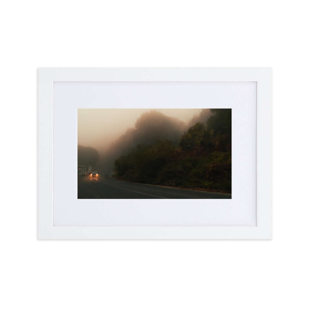 White Framed Photograph of a car driving in a foggy scenery