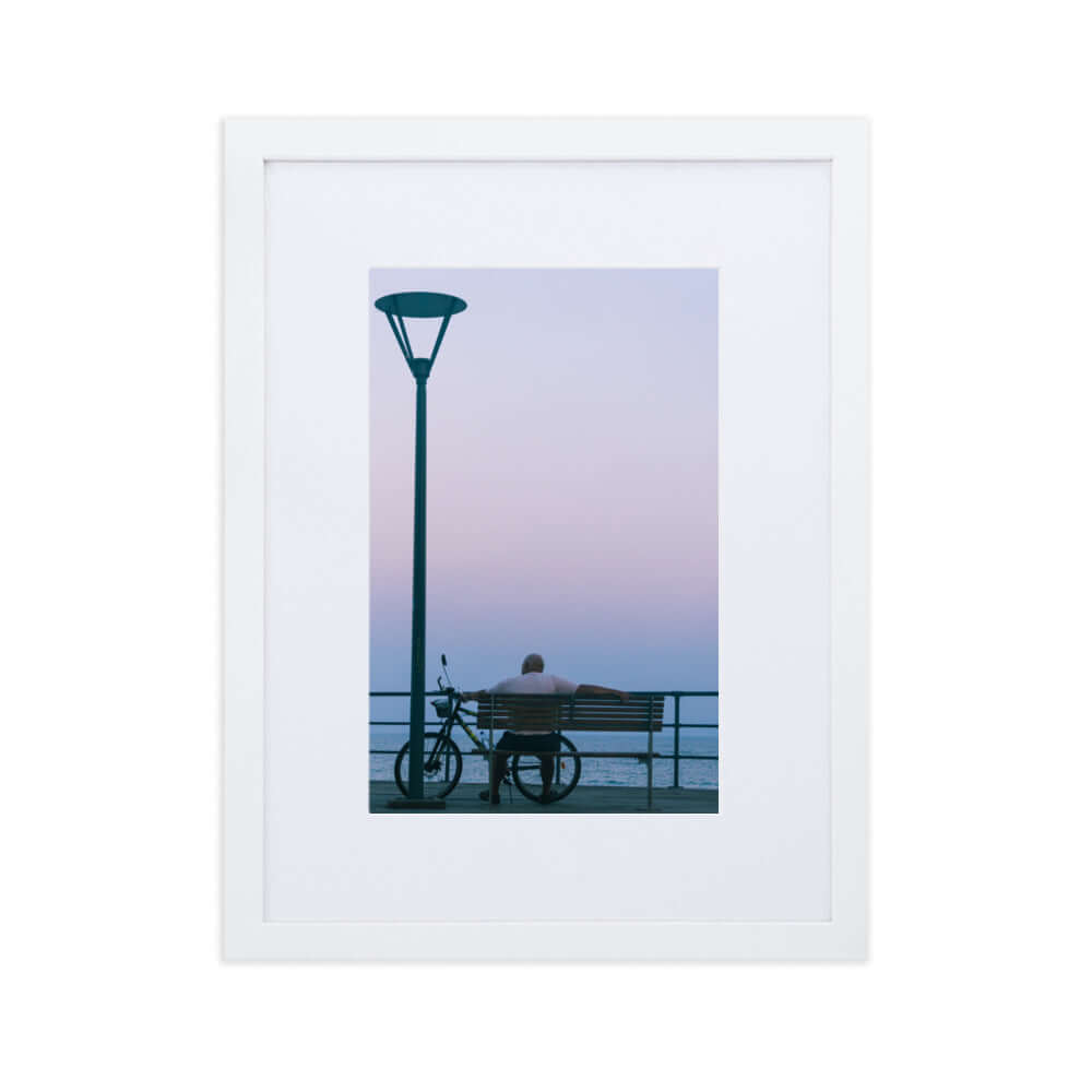 Man sitting on a bench during sunset