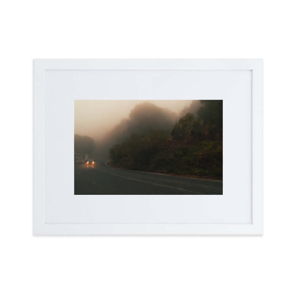 White Framed Photograph of a car driving in a foggy scenery