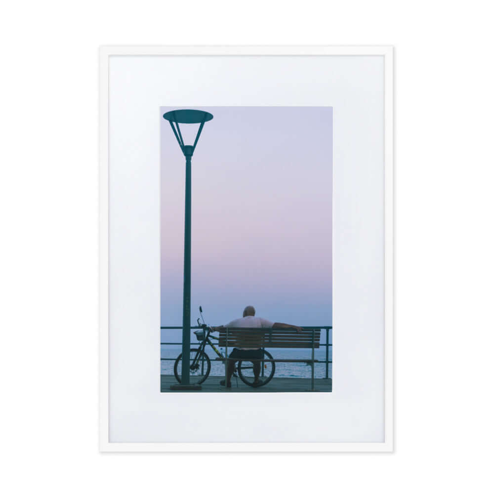 Man sitting on a bench during sunset