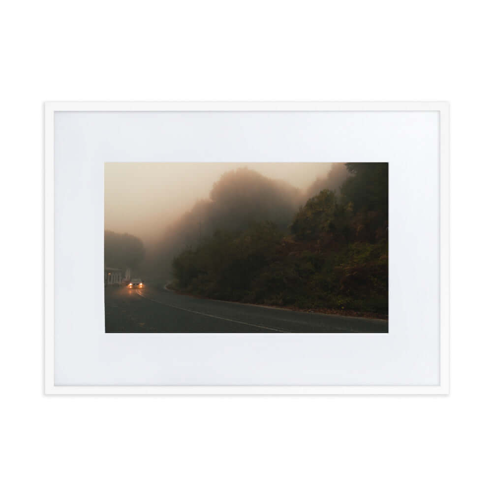 White Framed Photograph of a car driving in a foggy scenery