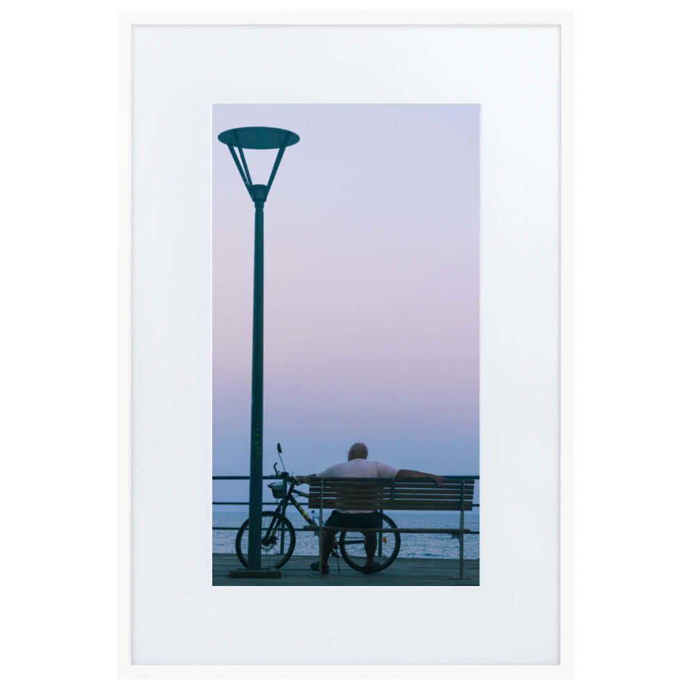 Man sitting on a bench during sunset