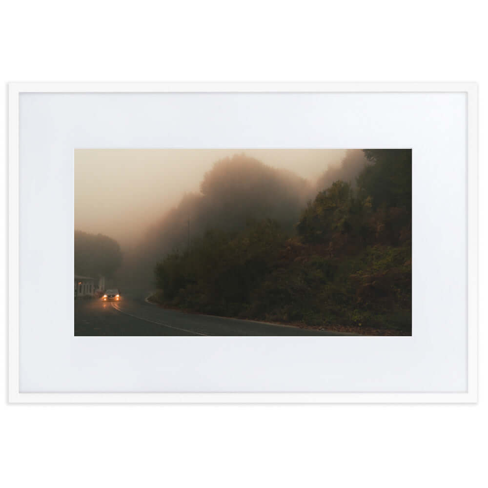 White Framed Photograph of a car driving in a foggy scenery