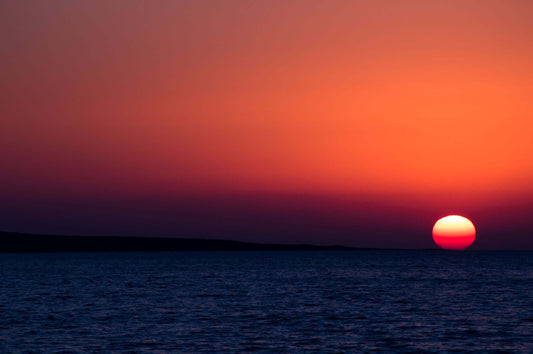 Sunset diving into the sea