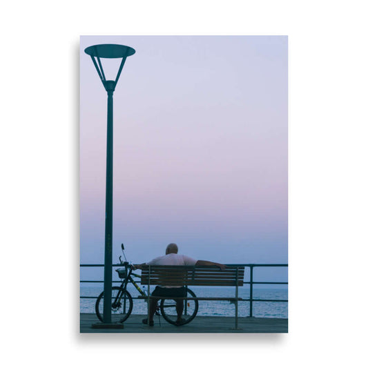 Man sitting on a bench during sunset